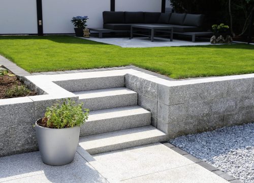 Neat and tidy garden with granite wall and solid block steps