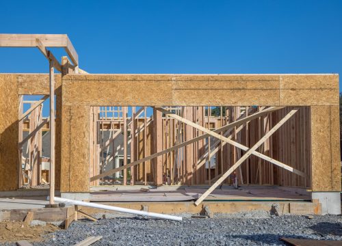 wooden natural house construction against the sky new window