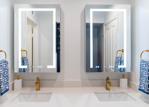 A bathroom scene displaying two mirrors and a sleek shower.