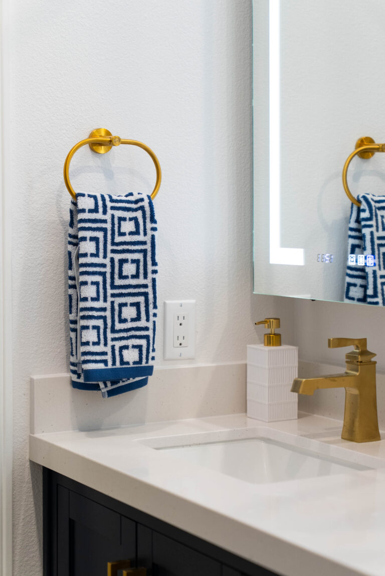 A modern bathroom scene with a white sink and a gold sink, reflecting a blend of elegance and functionality.