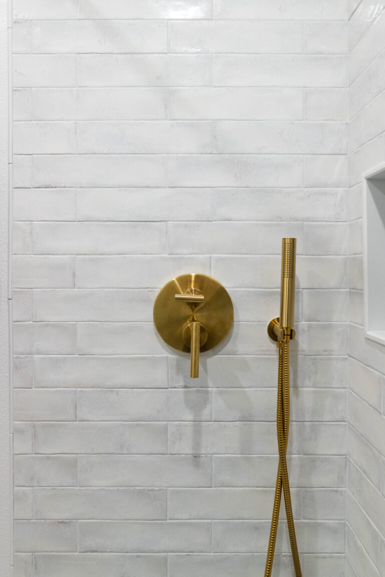 A modern bathroom featuring a shower and an elegant vanity, showcasing a clean and functional design.