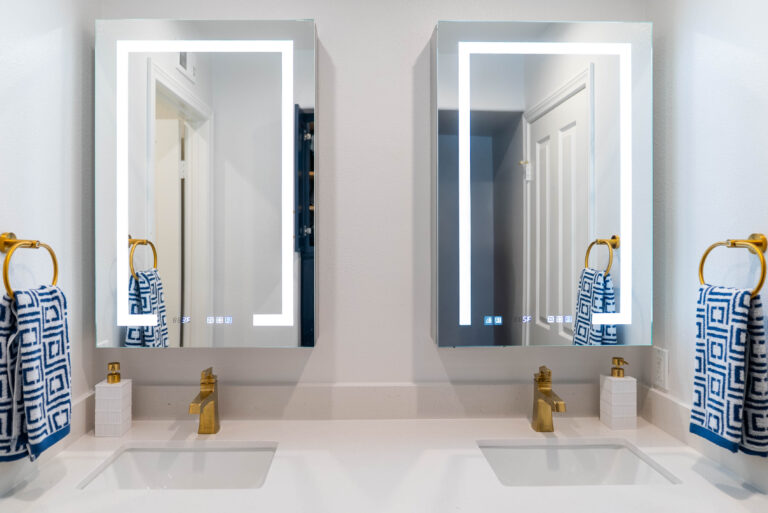 A bathroom scene displaying two mirrors and a sleek shower.